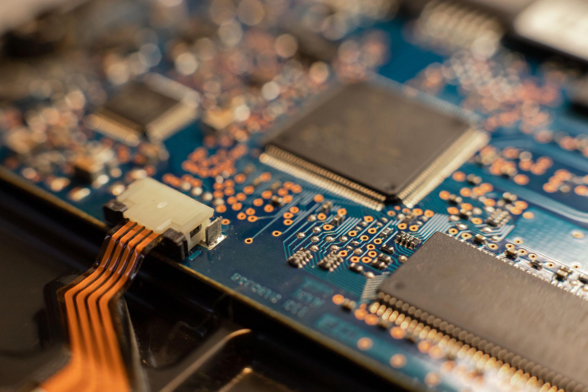 Close-up photograph of a modern integrated circuit (microchip) showing its complex circuitry